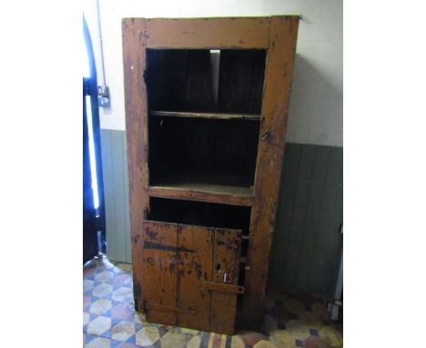 A rustic vintage floorstanding side cupboard, partially enclosed by a ledge and brace door with distressed paint work and she