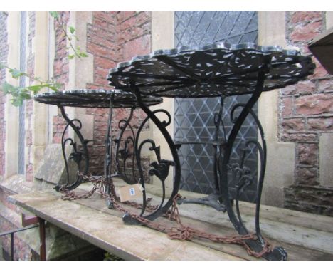 A pair of painted cast aluminium garden terrace tables of circular form with pie crust outline and decorative pierced foliate