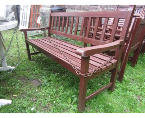 A contemporary stained hardwood three seat garden bench with slatted seat and back, 5 ft long approx.