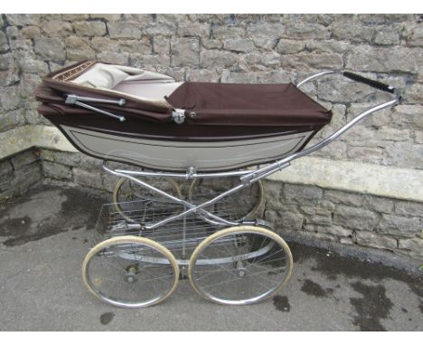 A vintage coach built pram by Marmet with sprung chromium plated frame and under tray