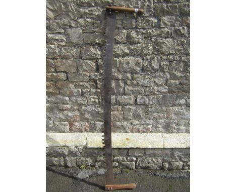 A vintage two man saw with ashwood handles.