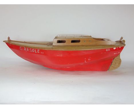 A vintage wooden cabin cruiser inscribed 'Girasole' with red painted body, 90 cm long approx.