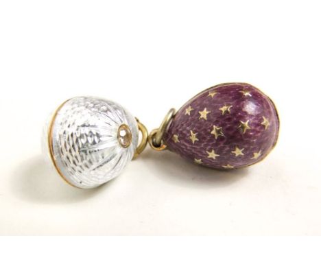 A pair of continental (possibly Russian) quilloche enamel charms, one decorated in relief with a scorpion amidst stars, the o