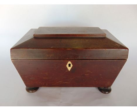 A 19th century sarcophagus tea caddy with partly fitted interior.