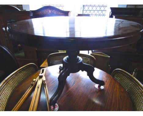 A Victorian mahogany tea table raised on a turned pillar and tripod base.