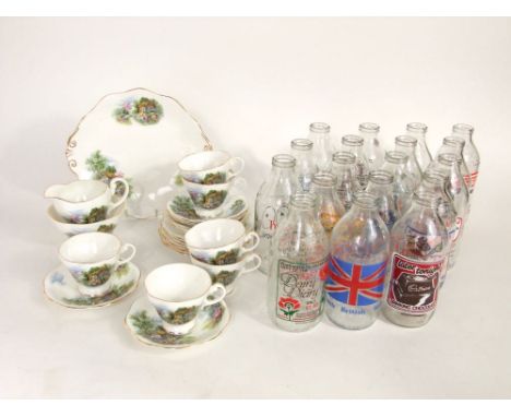A collection of various vintage advertising milk bottles together with a porcelain part tea service in the Crinoline Lady pat