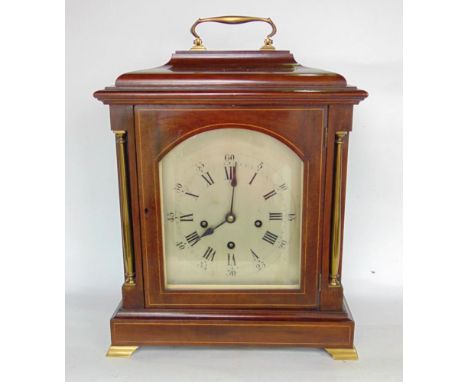 A continental Edwardian walnut three train bracket clock, the 23 cm approx arched silvered dial in a box wood inlaid case fit