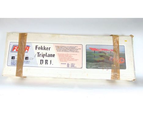 A cased scale replica of a Fokker Tri-plane in original packaging.