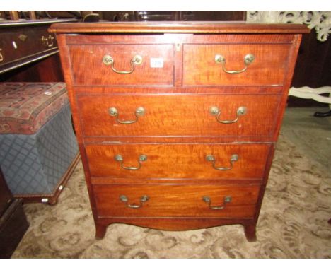 A small mahogany commode presented as a chest of three long and two short drawers on swept supports, the partially reconstruc