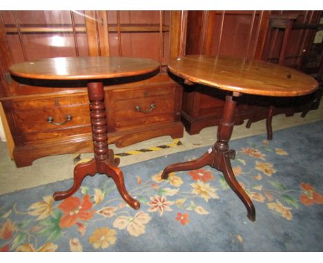 A Georgian oak country made snap top table raised on a turned pillar and tripod base together with a further mahogany example