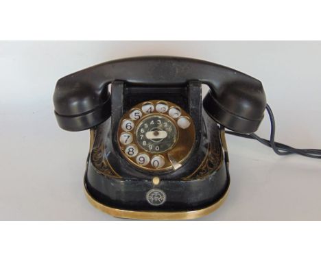 A good vintage telephone with brass carry handle and gilt decoration.