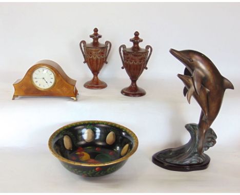 A pair of cast copper campania urns with faceted detail together with a further cast metal study of leaping dolphins, an earl