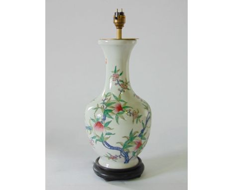 A Chinese porcelain baluster vase converted to a lamp, decorated with pomegranates upon a white ground, 36 cm high approx (wi