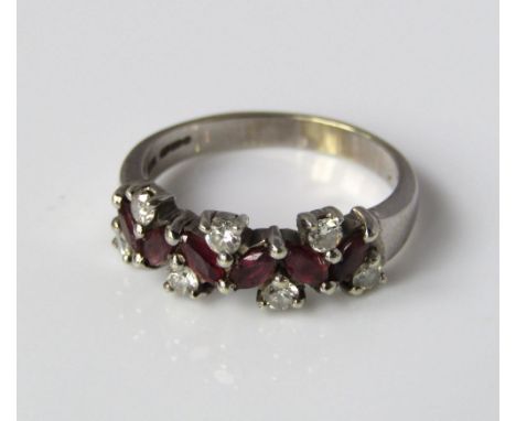 A 9ct white gold ladies ruby and diamond dress ring 6 marquise cut rubies flanked by 9 single cut diamonds 3.5g ring, size N 