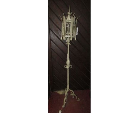 Ironware lamp standard loosely in the Gothic style the lantern casing of hexagonal format raised on a turned column and tripo