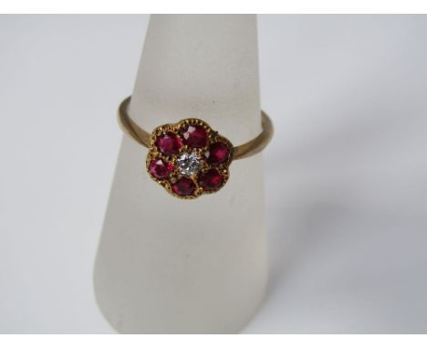 A 9ct gold ruby and diamond flower head ring, size O, 2g