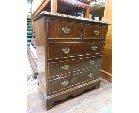 A small reproduction Georgian style chest of three long and two short drawers with brass plate handles on bracket supports, 6