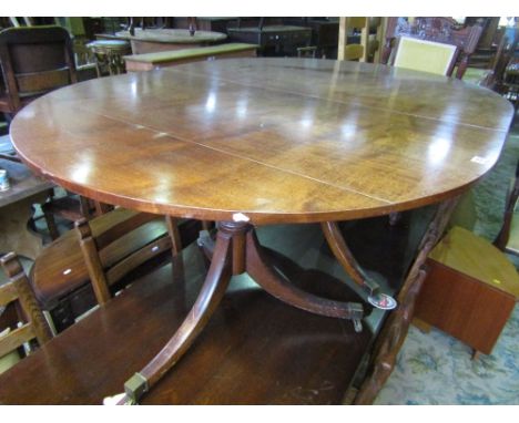 Georgian mahogany D end extending dining table raised on a pair of turned pillars and swept tripod bases with additional cent