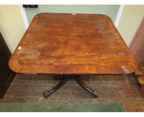 A Georgian mahogany occasional table, the rectangular top with crossbanded border, raised on a turned pillar and tripod base 