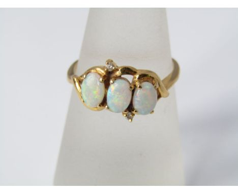 A triple opal and diamond ring in yellow metal, size P/Q, 4g