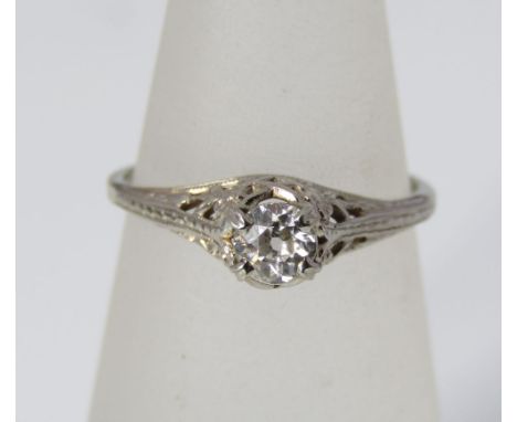 A solitaire diamond ring, marked 14k, in pierced floral setting, size J/K, 1g