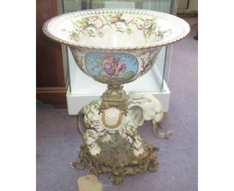 TAZZA, Sevres style ceramic, the pierced bowl with foliate and floral detail on top of an elephants on a gilt metal base, 41c