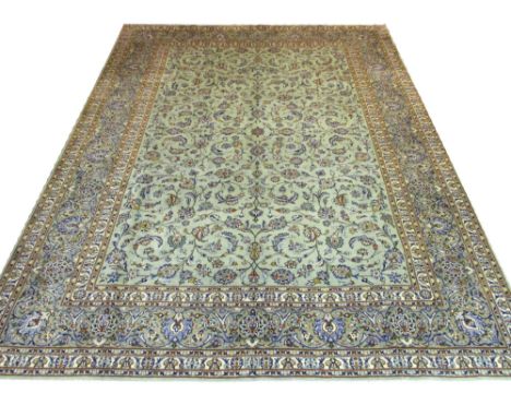 FINE KASHAN CARPET, 390cm x 295cm, all over palmette and vine design on a jade field within corresponding borders.