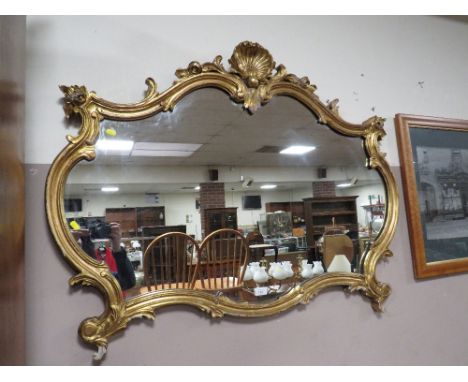 A 19TH CENTURY GOLD GILDED CARVECD WOODEN WALL MIRROR WITH PEARL AND SHELL CENTRAL FINIAL- W-115 CM