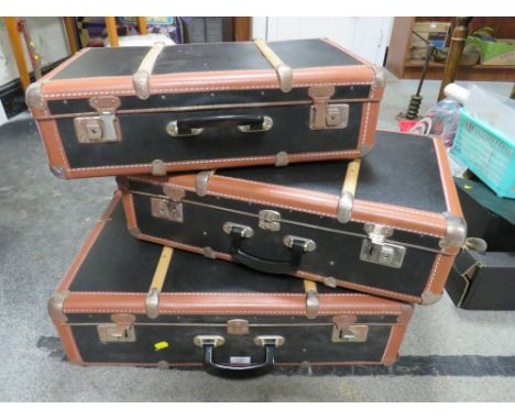 A SET OF THREE VINTAGE BANDED SUITCASES