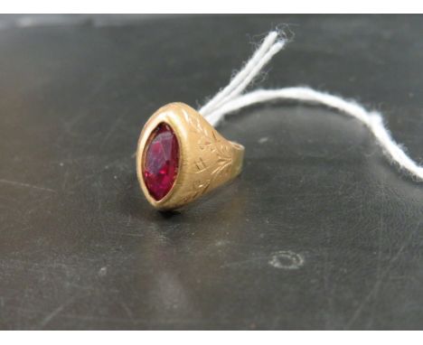 A MARQUISE SHAPED CONTINENTAL RING STAMPED 750 SET WITH A RUBY STYLE STONE - APPROX WEIGHT 4 G