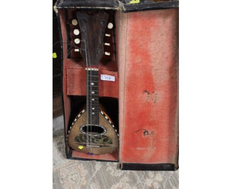 A VINTAGE CASED MANDOLIN WITH TORTOISESHELL AND MOTHER OF PEARL INLAY