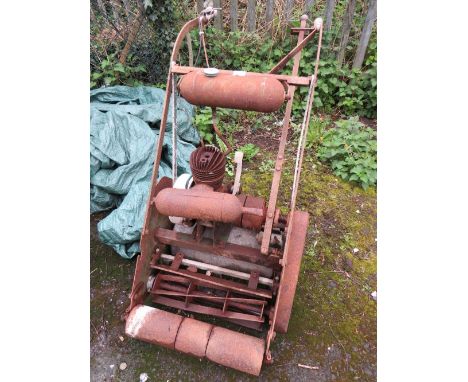A LARGE VINTAGE CAST PETROL MOWER