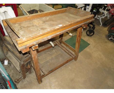 A VINTAGE WOODEN TRESTLE BENCH WITH MANGLE ATTACHMENT ETC