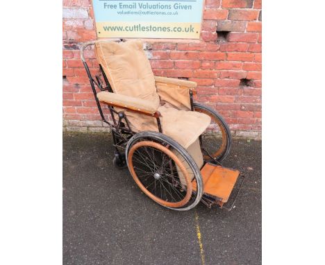 A VINTAGE INVALID CARRIAGE WITH WOODEN BANDED WHEELS