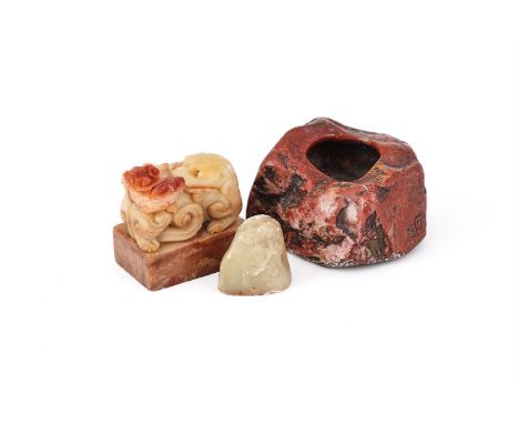 A Chinese soapstone washer, 19th century, of naturalistic design, incised with shi gu mark to the side, 6cm long x 5cm wide; 