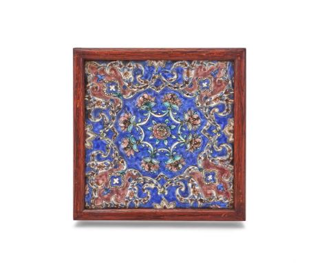 A Qajar Tile, Persia, circa 1880, moulded in relief with interlocking floral and leaf motifs glazed in aubergine, turquoise a