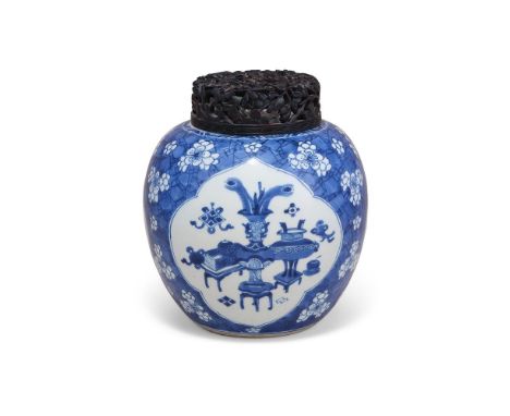 A Chinese blue and white ginger jar, Kangxi, painted with three quatrefoil cartouches depicting censers and archaistic vases,