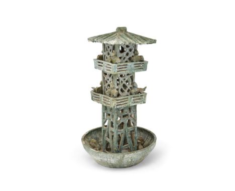 A Chinese two-tier green glazed pottery model of a watch tower, Han Dynasty (202BC- 220AD), standing within a basin with appl