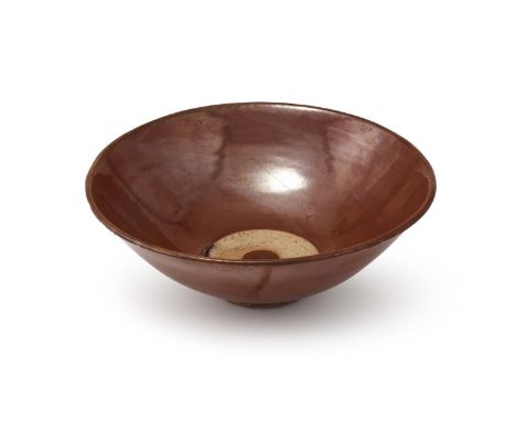 A Chinese persimmon glazed bowl, Song Dynasty (960-1279), the bowl covered overall with a russet-brown glaze except for a rin