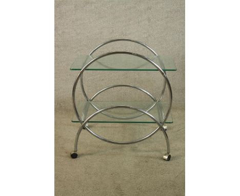 A mid century glass and chrome two shelf modernist trolley raised on plastic wheels. H.73 W.67 D.42cm. 