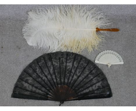 Three assorted 20th century fans to include black lace and plastic fan, a white plastic stick fan and an ostrich feather fan 