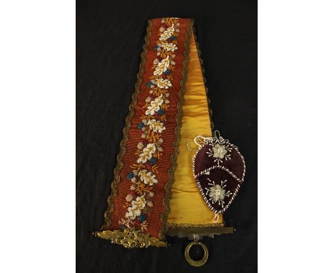 An early 20th century Scandinavian beadwork sash decorated with flowers together with a velvet stumpwork style ladies purse w