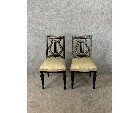 A pair of 19th century ebonised and mother of pearl inset chairs with stuffover seats raised on turned supports. H.85cm 