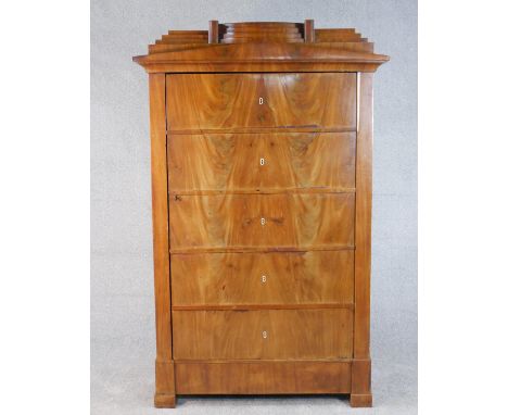 A Biedermeier figured walnut escritoire converted to a cabinet, the step down cornice over a door in the form of five drawer 