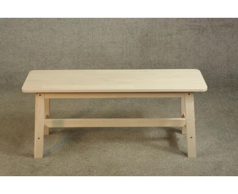 A contemporary limed beech bench raised on four splayed supports with cross stretcher. H.46 W.103cm. 