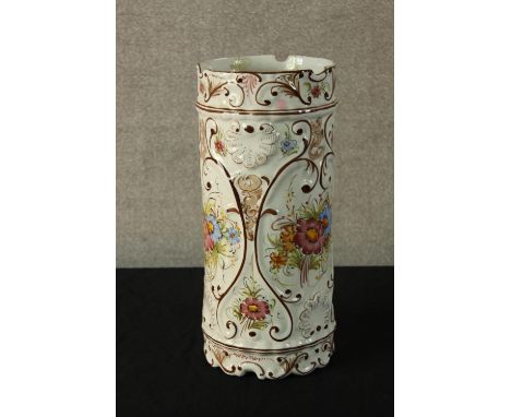 A contemporary Portuguese tin glazed faience cylindrical stick stand decorated with sprays of flowers. (Cracked) H.43 Dia.19c