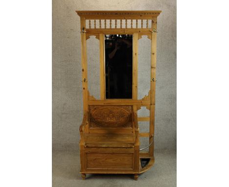 A contemporary stripped Keenpine mirror back hallstand with integral storage seat and umbrella/stick stand raised turned feet