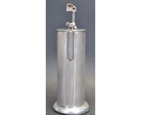 A vintage 20th century Parker Roller Beacon table lighter of cylindrical form having an engine turned case raised on a circul