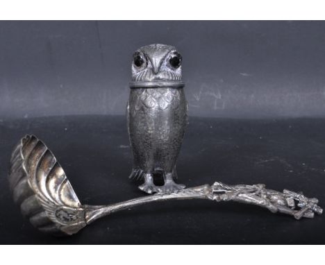 An early 20th century silver plate novelty owl pepper pounce pot with red glass eyes together with a Victorian owl silver pla