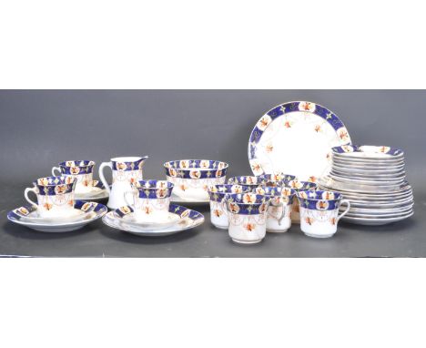 An early 20th century Royal Albert T.C. Wild Crown china tea service comprising of ten cups, twelve saucers, twelve side plat